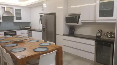 a kitchen with a wooden table with blue plates on it at 109 da Gama on Beach in Strand