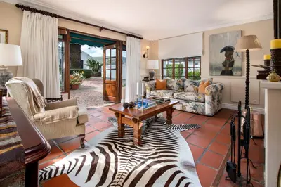 a living room with a zebra rug at La Fontaine Guest House Hermanus in Hermanus