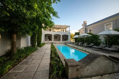 a swimming pool in the backyard of a house at Maison d'Ail Guest House in Franschhoek