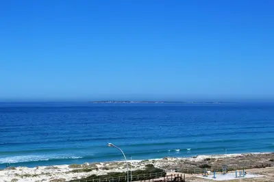 a view of the ocean from a beach with a street light at 605 Nautica in Bloubergstrand
