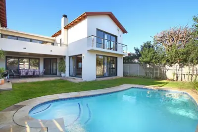a house with a swimming pool in the yard at Sunset at Granula in Cape Town