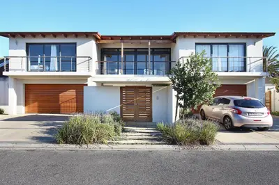 a house with a car parked in front of it at Sunset at Granula in Cape Town