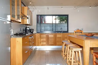 a kitchen with wooden cabinets and a wooden table at Sunset at Granula in Cape Town