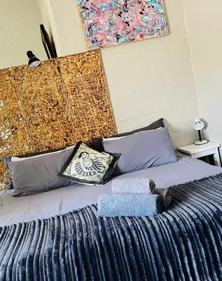 a bedroom with a bed with a large headboard at Lemontree in Hermanus