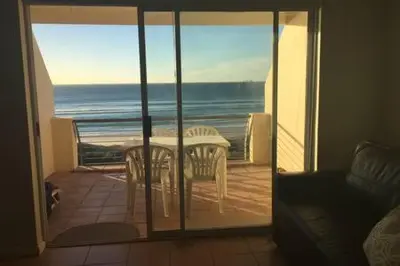 a view of the ocean from a balcony with a table and chairs at 325 Leisure Bay Cape Town in Cape Town