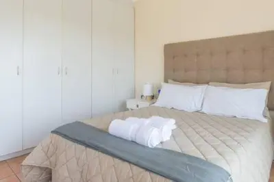 a bedroom with a large bed with two pillows at 325 Leisure Bay Cape Town in Cape Town