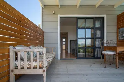 a porch with a bench and a sliding glass door at 29 Earlibelle in Stellenbosch