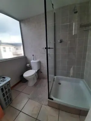 a bathroom with a shower and a toilet and a tub at Siesta in Hermanus