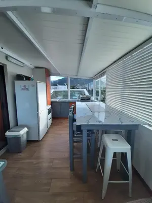a kitchen with a blue table and a refrigerator at Siesta in Hermanus