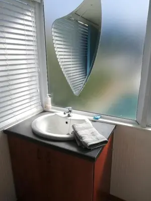 a bathroom with a sink and a mirror at Siesta in Hermanus