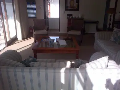 a living room with two couches and a coffee table at Pelagus Guest House in Hermanus