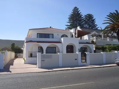 a large white house on the side of a street at Nautilus Guest House in Hermanus