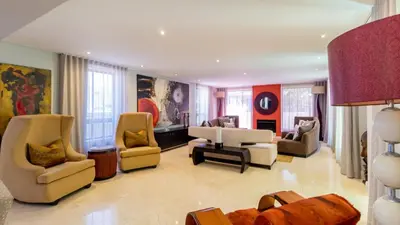 a living room with couches and chairs at Atlantic Waves Guest House in Cape Town