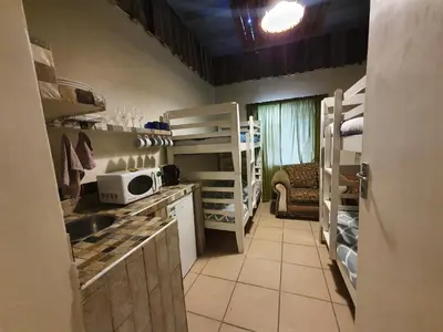 a kitchen with a sink and a microwave at Bedrock Guest Studios in Strand