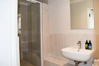 a bathroom with a sink and a shower at Knorhoek Country Guesthouse in Stellenbosch