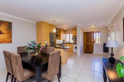 a kitchen and dining room with a table and chairs at Devonvale Golf & Wine Estate in Stellenbosch