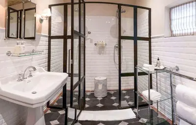 a bathroom with a sink and a shower at La Clé Lodge in Franschhoek