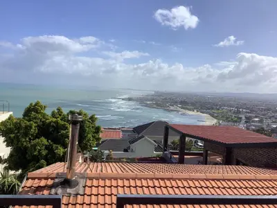 a view of the ocean from the roof of a building at Studio with unforgettable View in Gordonʼs Bay
