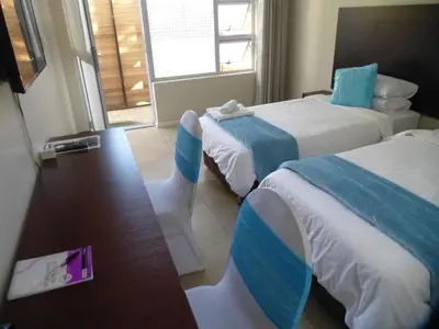 a hotel room with two beds and a window at Cape Town Milnerton Lagoon Villa in Cape Town