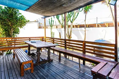 a wooden deck with a table and benches on it at Cape Town Milnerton Lagoon Villa in Cape Town