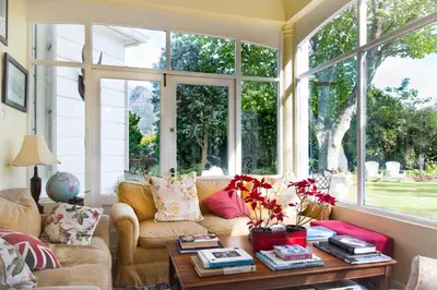 a living room with a couch and a table at Brooklands House in Cape Town