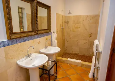 a bathroom with two sinks and a shower at Hotel du Vin Franschhoek in Franschhoek