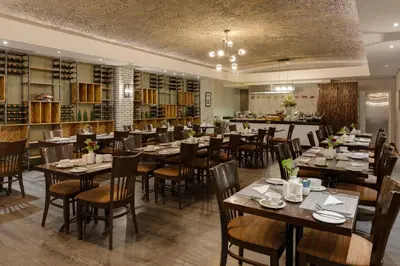 a restaurant with tables and chairs in a room at Protea Hotel by Marriott Cape Town Durbanville in Bellville