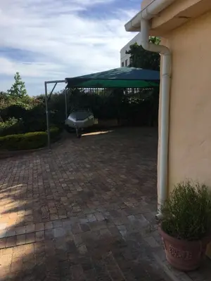 a pavilion with a green canopy on a patio at Geranium Studio in Somerset West