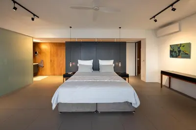 a bedroom with a large bed and a piano at '22 Protea' - Luxury, Style and Elegance - Sleeps 12 in 6 En-suite Bedrooms in Gordonʼs Bay