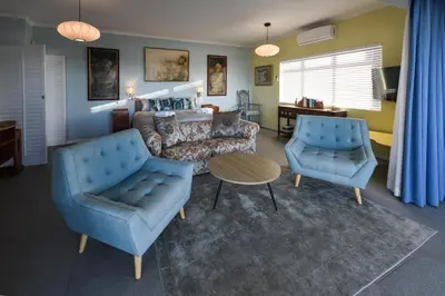 a living room with a couch and two chairs at Die Badhuis, for Fabulous living! Sleeps 4, Private pool in Gordonʼs Bay