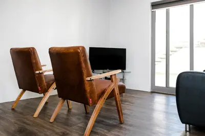 a desk with two chairs and a computer monitor at Zeederberg Corner in Paarl