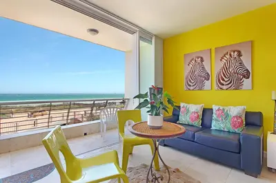 a living room with a couch and a table at Neptune Isle 214 in Cape Town