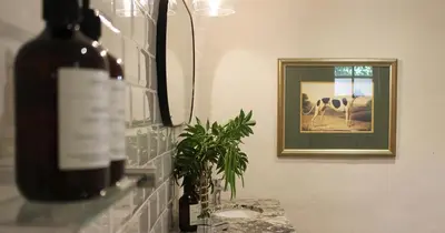a bottle of wine on a counter in a bathroom at Mount Grace Country House in Greyton