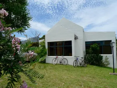two bikes parked in front of a white house at Sky house on Clarens in Bettyʼs Bay