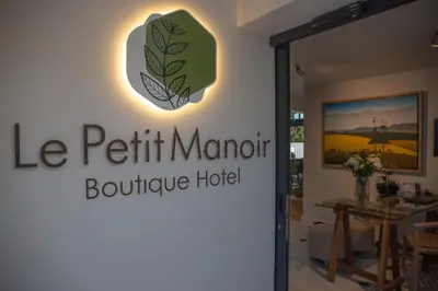 a sign for the le petit maurit boutique hotel at Le Petit Manoir Boutique Hotel in Franschhoek