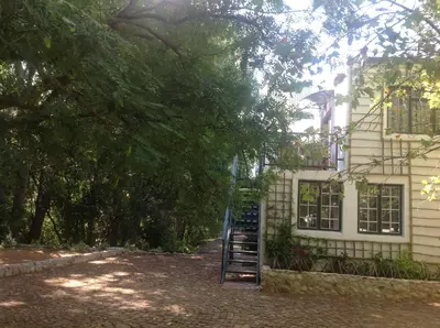 a staircase in front of a house with a building at Willow Brooke Guest Suite in Franschhoek