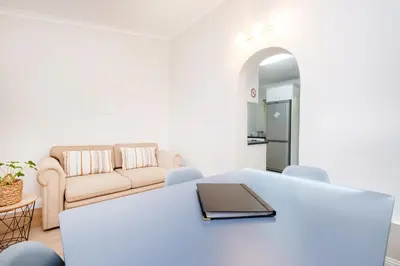 a living room with a table and a couch at 10VDW Self Catering Apartments-Newly Renovated! in Durbanville