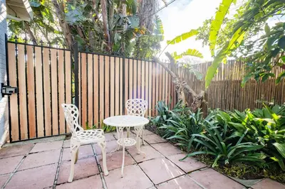 a table and two chairs on a patio with a fence at 10VDW Self Catering Apartments-Newly Renovated! in Durbanville