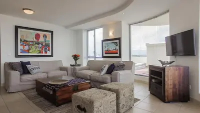 a living room with a couch and a tv at Hibernian Towers 505 in Strand
