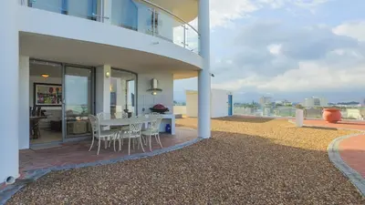 a balcony of a house with a table and chairs at Hibernian Towers 505 in Strand