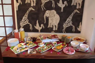 a table full of food with giraffes and other foods at Orange-Ville Lodge & Guesthouse in Stellenbosch