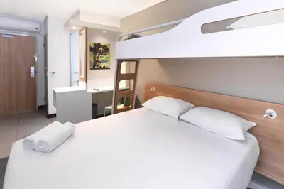 a bedroom with a bunk bed with white pillows at SUN1 MILNERTON in Cape Town
