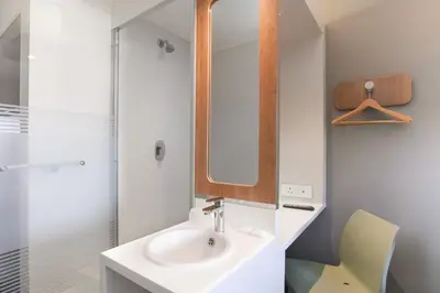a bathroom with a sink and a mirror at SUN1 MILNERTON in Cape Town