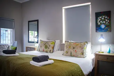 a bedroom with a bed with two towels on it at Olive tree private rooms in Stellenbosch- No Load Shedding in Stellenbosch