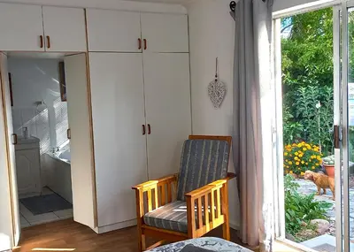 a living room with a chair and a window at 19 on Robyn in Durbanville