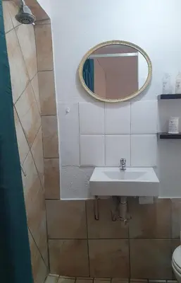 a bathroom with a sink and a mirror at 19 on Robyn in Durbanville