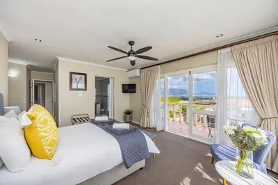 a bedroom with a bed and a balcony at Plattekloof Premium Lodge in Plattekloof