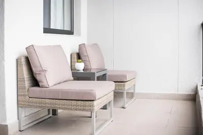 two chairs and a table in a room at Waters Edge Self-Catering Apartment in Cape Town