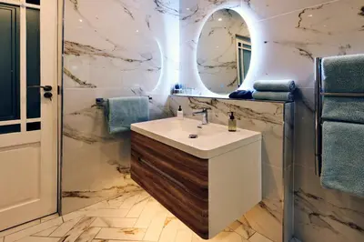 a bathroom with a sink and a mirror at The Coach House in Franschhoek