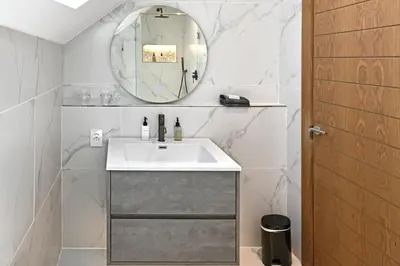 a bathroom with a sink and a mirror at The Coach House in Franschhoek